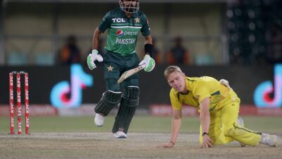 Babar Azam, left, takes a run while Australia's Nathan Ellis looks on. AP