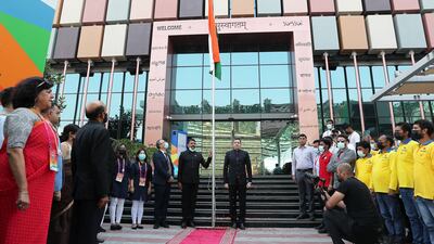 Consul General of India Dr Aman Puri, centre-right, hoists a flag.