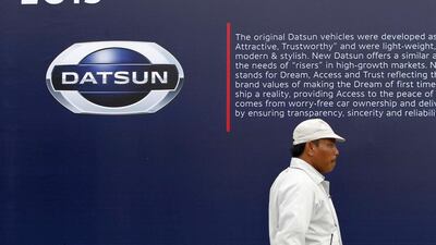 A worker walks near a Datsun logo at a Nissan Indonesia factory in Purwakarta, Indonesia. Beawiharta / Reuters