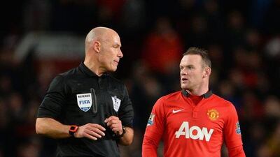 Wayne Rooney, right, of Manchester United protests to referee Howard Webb during his team's Premier League match against Tottenham Hotspur at Old Trafford on Wednesday night. Michael Regan/Getty Images