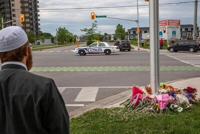 A police car passes the location where a family of five was hit by a driver, in London, Ontario, Monday, June 7, 2021. AP Photo