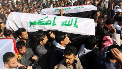 Iraqis carry the coffins of Sunni clerics assassinated near Basra city on January 2, 2015. EPA
