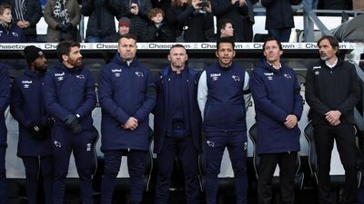 Wayne Rooney, centre, with Shay Given, centre left, and Derby manager Phillip Cocu, right, during the Championship match between Derby County and Millwall at Pride Park Stadium on December 14. Getty Images