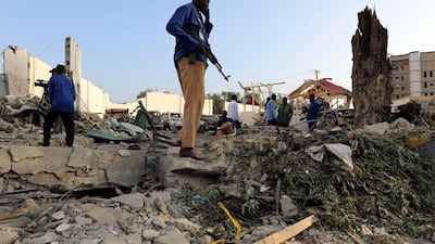 Security officers stand at the scene after a suicide car explosion in front of Doorbin hotel in Mogadishu, Somalia February 24, 2018. Feisal Omar / Reuters