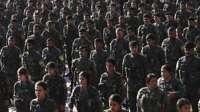 Fighters from the Syrian Democratic Forces (SDF), participate in a military parade during the funeral of a fellow fighter, killed in an offensive by ISIS against an SDF position, in the Kurdish-controlled city of Qamishly in northeastern Syria. AFP
