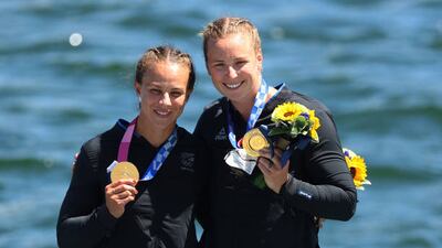 Gold medalists Lisa Carrington and Caitlin Regal of Team New Zealand celebrate at the medal ceremony for the Women's Kayak Double 500m Final.