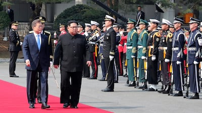 The leaders inspect a guard of honour. Korea Summit Press Pool via AP