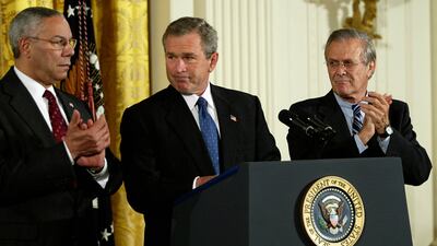 President George W Bush in 2003 with his secretary of state Colin Powell, left, and defence secretary Donald Rumsfeld. AFP