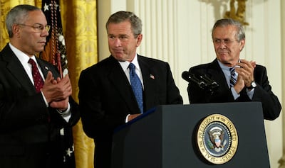 Then-president George W Bush, flanked by his secretary of state Colin Powell and defence secretary Donald Rumsfeld, in November 2003. AFP