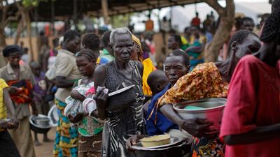 South Sudanese refugees queue for food in northern Uganda. where 1 million are sheltering. Ben Curtis / AP