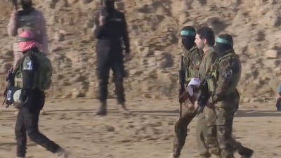 Israeli hostage Ofer Kalderon, held in Gaza since October 7, 2023, is accompanied by Hamas fighters to his release on February 1 as part of a ceasefire and a hostages for detainees swap between Hamas and Israel in Khan Younis, southern Gaza Strip. Reuters