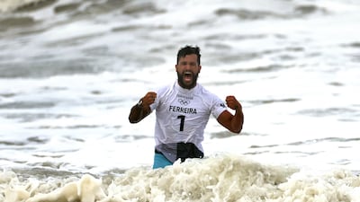 Italo Ferreira celebrates after winning the men's surfing gold medal.