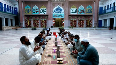People pray before breaking their fast in Lahore, Pakistan. AP Photo