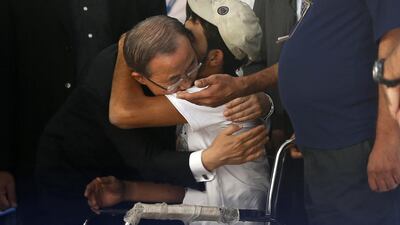United Nations Secretary-General Ban Ki-moon hugs wheelchair-bound Palestinian Mohammed Abed Al Dayem at a UN-run school in the northern Gaza Strip.