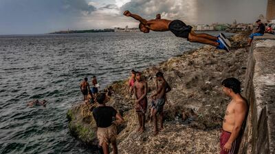 Youths bathe on Havana's Malecon waterfront in Cuba. AFP