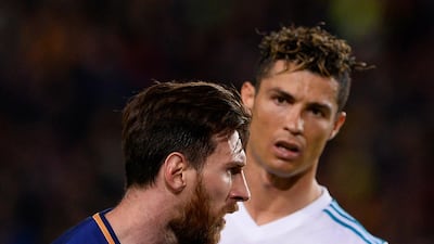 Arsene Wenger has revealed he tried to sign Cristiano Ronaldo, right, and Barcelona's Lionel Messi, left, during his 22-year reign as Arsenal manager. Josep Lago / AFP