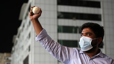 Abey Poulose collects a ball from the road outside Sharjah Cricket Stadium after a six hit by Kolkata Knight Riders' Shubman Gill. All photos by Chris Whiteoak / The National