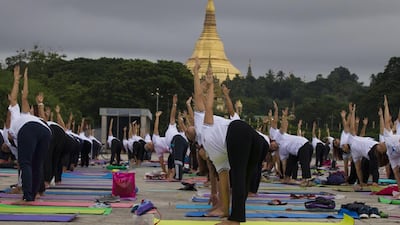 People practice yoga on International Yoga Day, in front of Shwedagon pagoda in Yangon, Myanmar. Thein Zaw / AP photo
