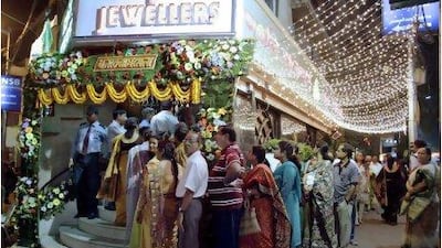 Buyers stand in a queue outside a jewelry shop during Dhanteras festival in Calcutta, India, Wednesday, Nov. 3, 2010. Hindus consider it auspicious to purchase gold, silver and utensils during Dhanteras, which marks the beginning of the five-day Diwali festival.
