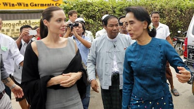UNHCR goodwill ambassador Angelina Jolie and Myanmar opposition leader Aung San Suu Kyi arrive at a Yangon slum. Nyein Chan Naing/EPA
