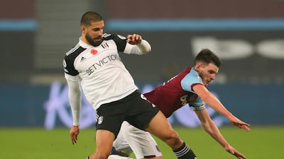 Fulham's Aleksandar Mitrovic, left challenges West Ham's Declan Rice at the London stadium. AP