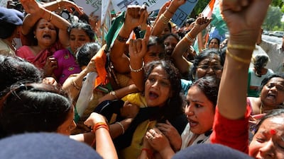 Women protest in New Delhi on August 22, 2014, after a cabinet minister remarked that a fatal gang rape in the capital in December 2012 was a “small incident”. Chandan Khanna / AFP