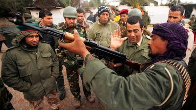 A rebel army officer teaches the use of weapons to civilians who have volunteered to join the rebel army in Benghazi.