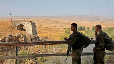 Israeli soldiers patrol the border fence in Baqura. AFP