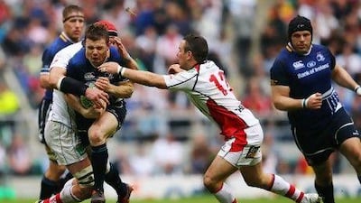 Leinster's Brian O'Driscoll is tackled by two Ulster players during the Heineken Cup final, which Leinster won.