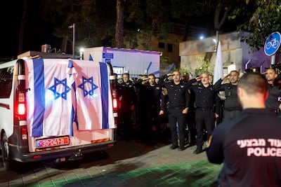 Israeli police officers salute the vehicle carrying the body of Ran Gvili. Reuters