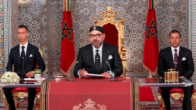 Morocco's King Mohammed VI delivers a speech on July 29, 2019, to mark the 20th anniversary of his accession to the throne, as his brother Prince Moulay Rachid, right, and son Prince Moulay Hassan, left, look on. AFP / Moroccan Royal Palace