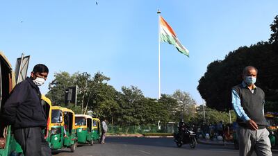 People wearing face masks to avoid spread of coronavirus walk in New Delhi, India. EPA
