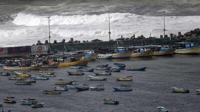 Boats of Palestinian fishermen are pictured off the coast of Gaza City, on a stormy day. AFP