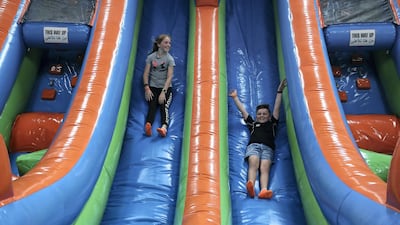 Harriet and Henry Osgerby on the inflatable slides at Air Maniax. Pawan Singh / The National