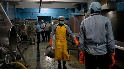 Labourers work inside the kitchen at the non-profit Akshaya Patra Foundation.