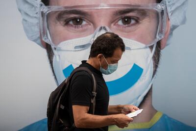 A man wearing a face mask to prevent the spread of coronavirus walks in the Vallecas neighborhood in Madrid, Spain, Saturday, September 19, 2020. AP