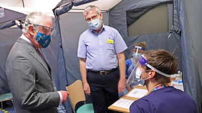 The Prince of Wales meets with NHS staff during a visit to a vaccination centre at Gloucestershire Royal Hospital. AFP.