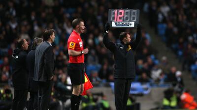 The board is held up showing 12 minutes of injury time to be played between Manchester City and Swansea City at the Etihad Stadium following injuries to Michel Vorm and Micah Richards. Clive Brunskill/Getty Images