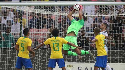 Brazil goalkeeper Alisson catches the ball during the match at King Abdullah Stadium. AP Photo
