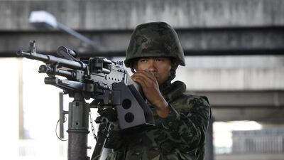 A Thai soldier mans a machine gun in central Bangkok. The army also called on media not to broadcast material that would affect national security. Chaiwat Subprasom / Reuters