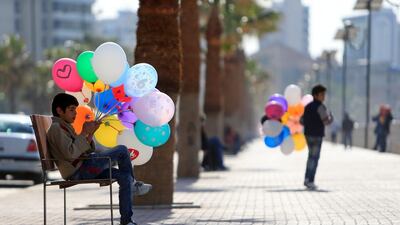 Syrian boys sell balloons along the corniche in the port city of Sidon, southern Lebanon. Ali Hashisho / Reuters