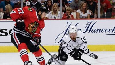 Los Angeles Kings centre Trevor Lewis, right, dives for the puck against Chicago Blackhawks centre Michael Frolik during Game 1 of their Western Conference finals on Saturday. Nam Y Huh / AP Photo
