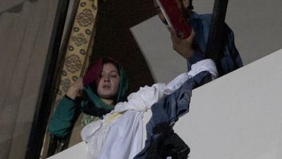 Guests wait for help at a hotel in Karachi, Pakistan, Monday, Dec. 5, 2016. A massive fire swept through the four-star hotel in the southern port city of Karachi on Monday. Shakil Adil / AP Photo