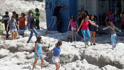 Residents play on top of ice after a heavy storm of rain and hail which affected Guadalajara, Mexico. Reuters