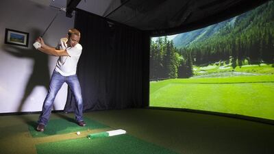 Travis Bundus, the managing partner of Performance Golf UAE, says the golf simulator is easy to get to grips with. Mona Al Marzooqi / The National