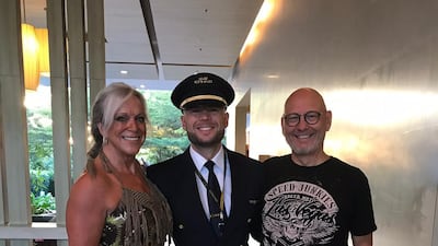 Mr van Gelder stands proudly in his pilots uniform with his parents, Saskia and Robert.