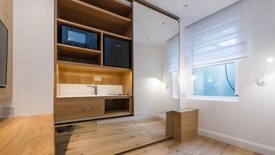 A mirrored wall panel can be pulled away to reveal the so-called kitchen facilities. Courtesy Harrods Estates