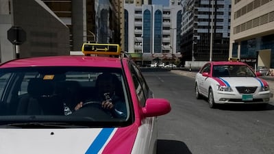 Advantage taxis drive up a side street in Sharjah. Commuters say the hike in taxi fares is unlikely to deter them from using cabs. Amy Leang / The National