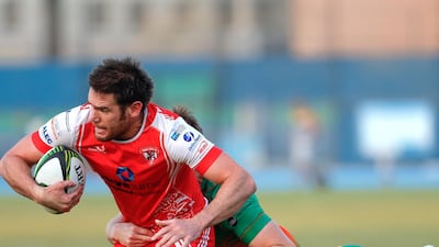 Peter Kelly of Dubai Tigers is tackled by a Dubai Knights Eagles player.