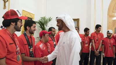 Sheikh Mohammed bin Zayed, Crown Prince of Abu Dhabi and Deputy Supreme Commander of the UAE Armed Forces (R), greets a member of the UAE Special Olympics team, during a Sea Palace barza. Mohamed Al Hammadi / Crown Prince Court - Abu Dhabi